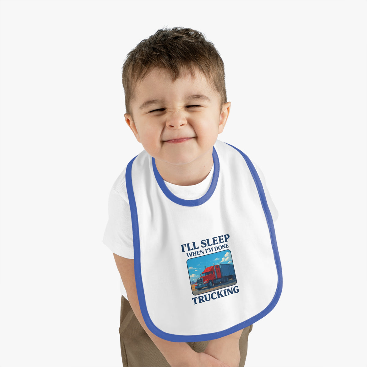 Funny trucking baby bib from Printify with "I'll Sleep When I'm Done" slogan, featuring white and black design for kids.