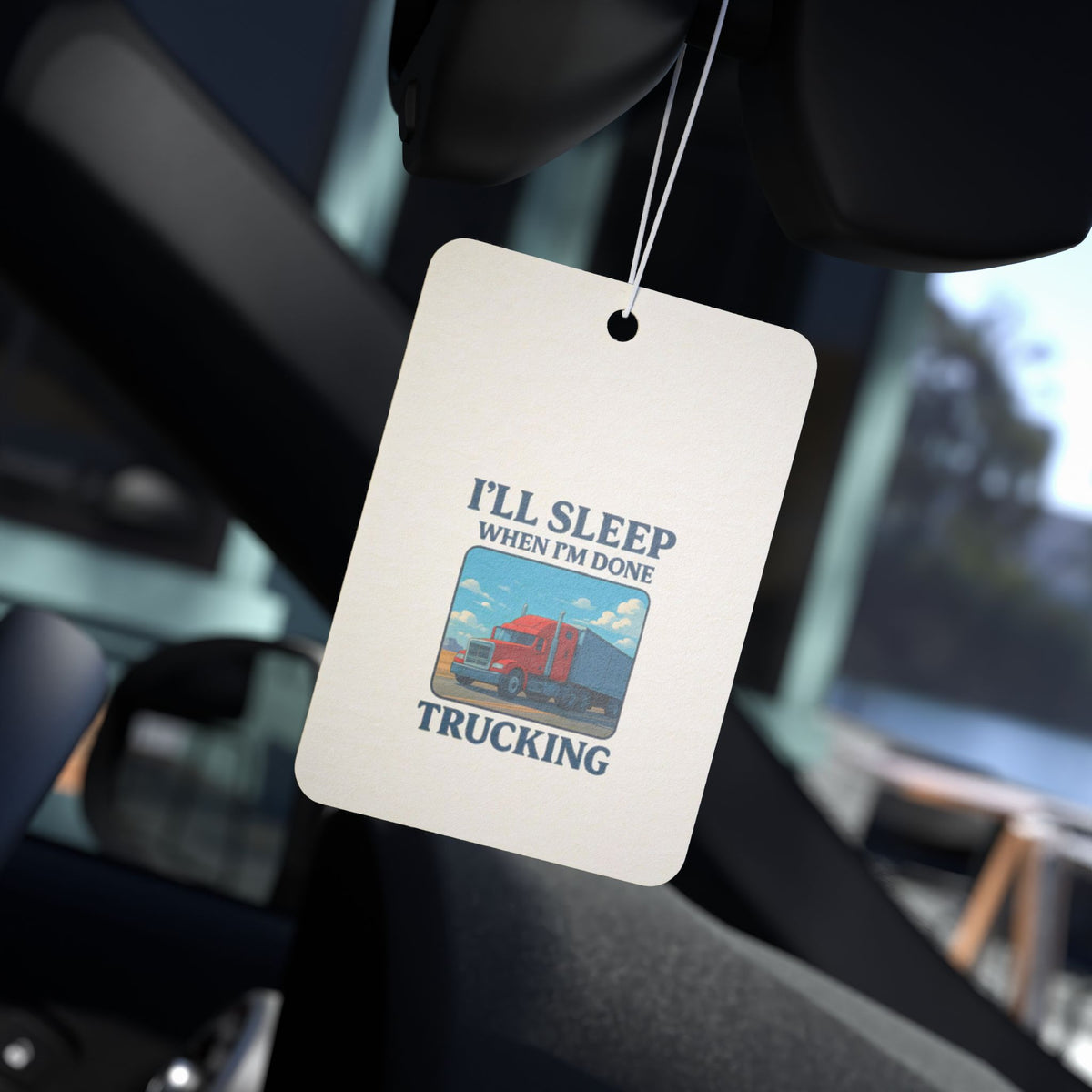 Truck driver car air freshener with "I'll Sleep When I'm Done" design, black and rectangular accessory for vehicle freshness.