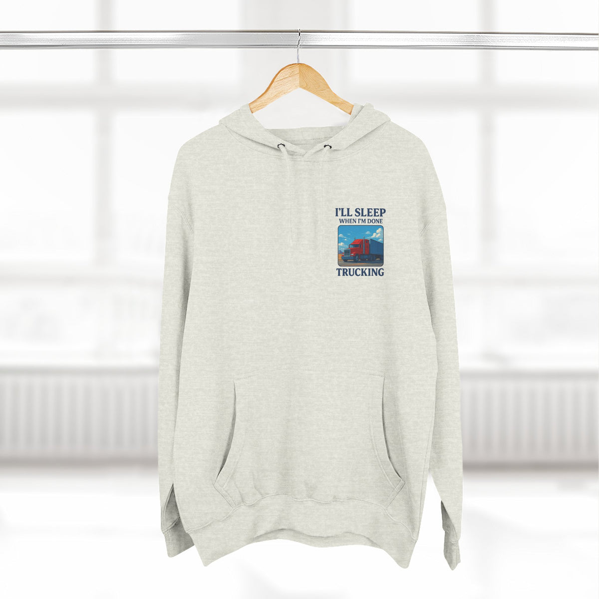 Heather grey Trucker's Fleece Hoodie by Printify featuring the phrase "I'll Sleep When I'm Done" displayed on the front.