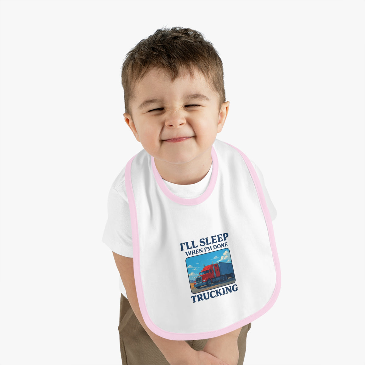 Funny trucking baby bib by Printify with "I'll Sleep When I'm Done" slogan, featuring white and black design for kids.