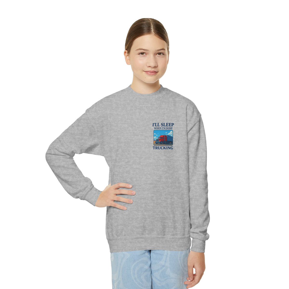 White youth crewneck sweatshirt by Printify featuring the slogan "I'll Sleep When I'm Done Trucking" in bold lettering.