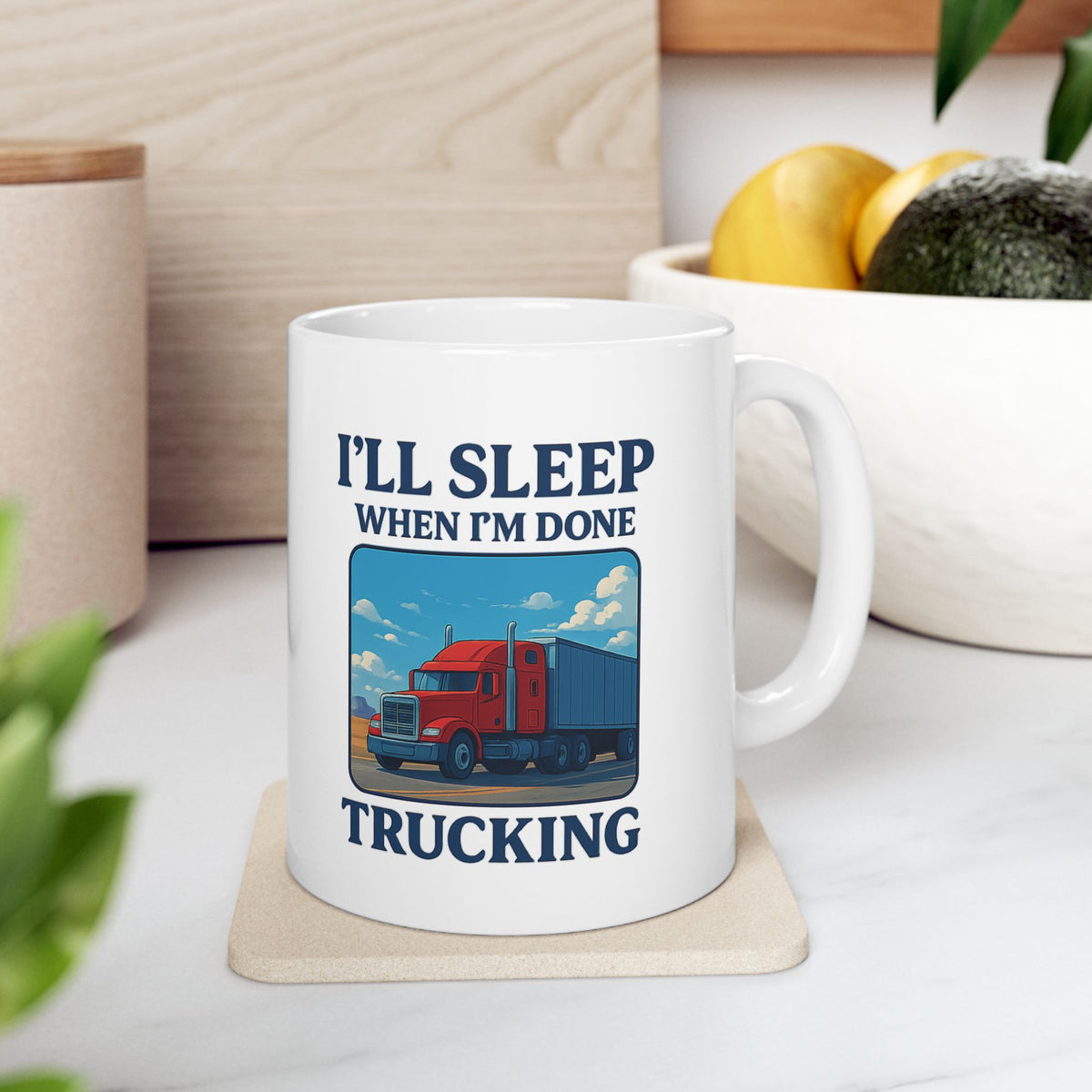 Ceramic mug with "I’ll Sleep When I’m Done Trucking" print, ideal for truck drivers, featuring a truck driver design on a white mug.