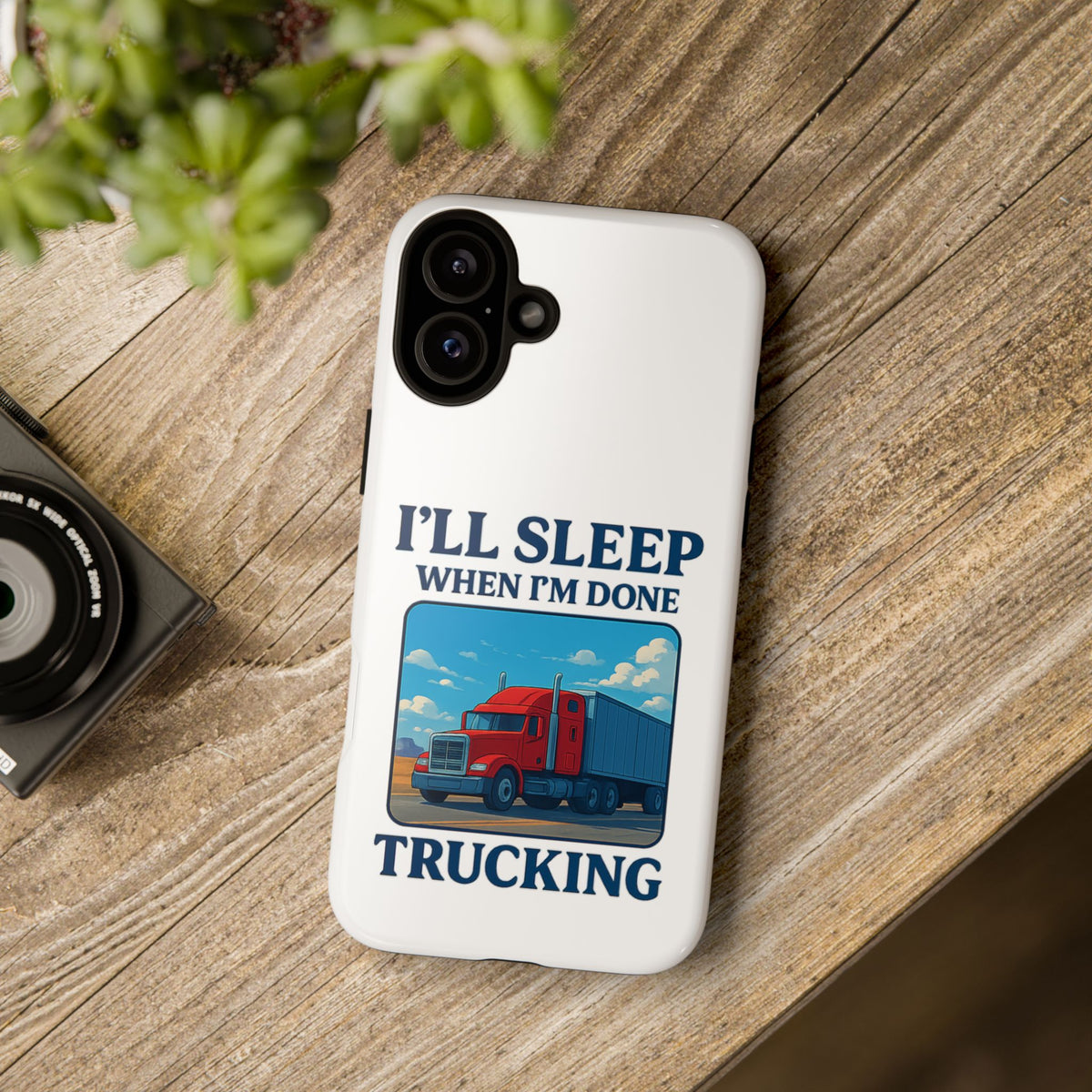 Glossy iPhone 16 Pro trucker phone case with the phrase "I'll Sleep When I'm Done Trucking" by Printify.