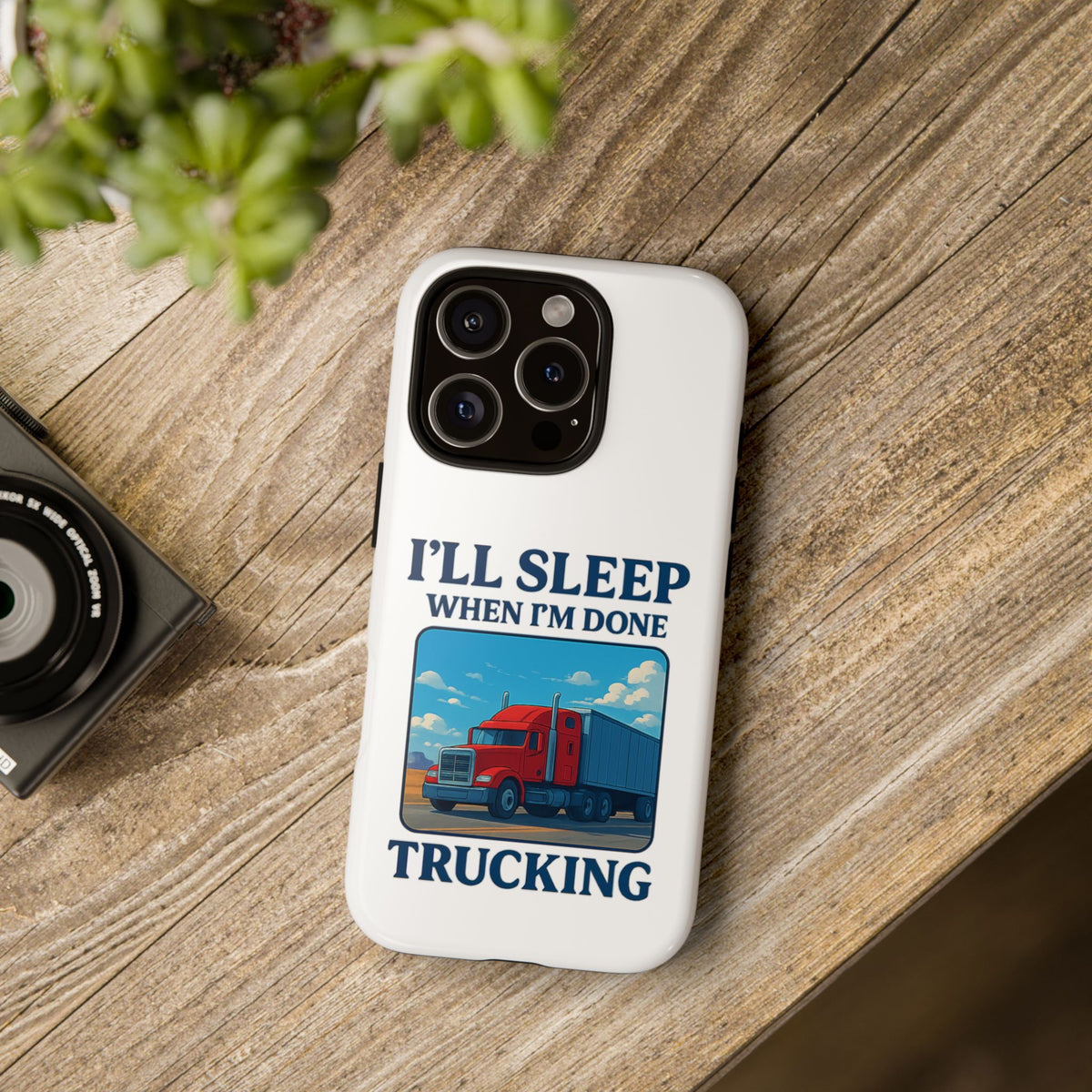 Glossy iPhone 16 Pro trucker phone case with humorous "I'll Sleep When I'm Done Trucking" design by Printify.