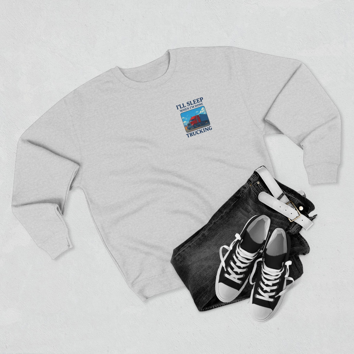 Heather grey Trucker Life unisex crewneck sweatshirt with "I'll Sleep When I'm Done" design, casual and comfortable apparel.