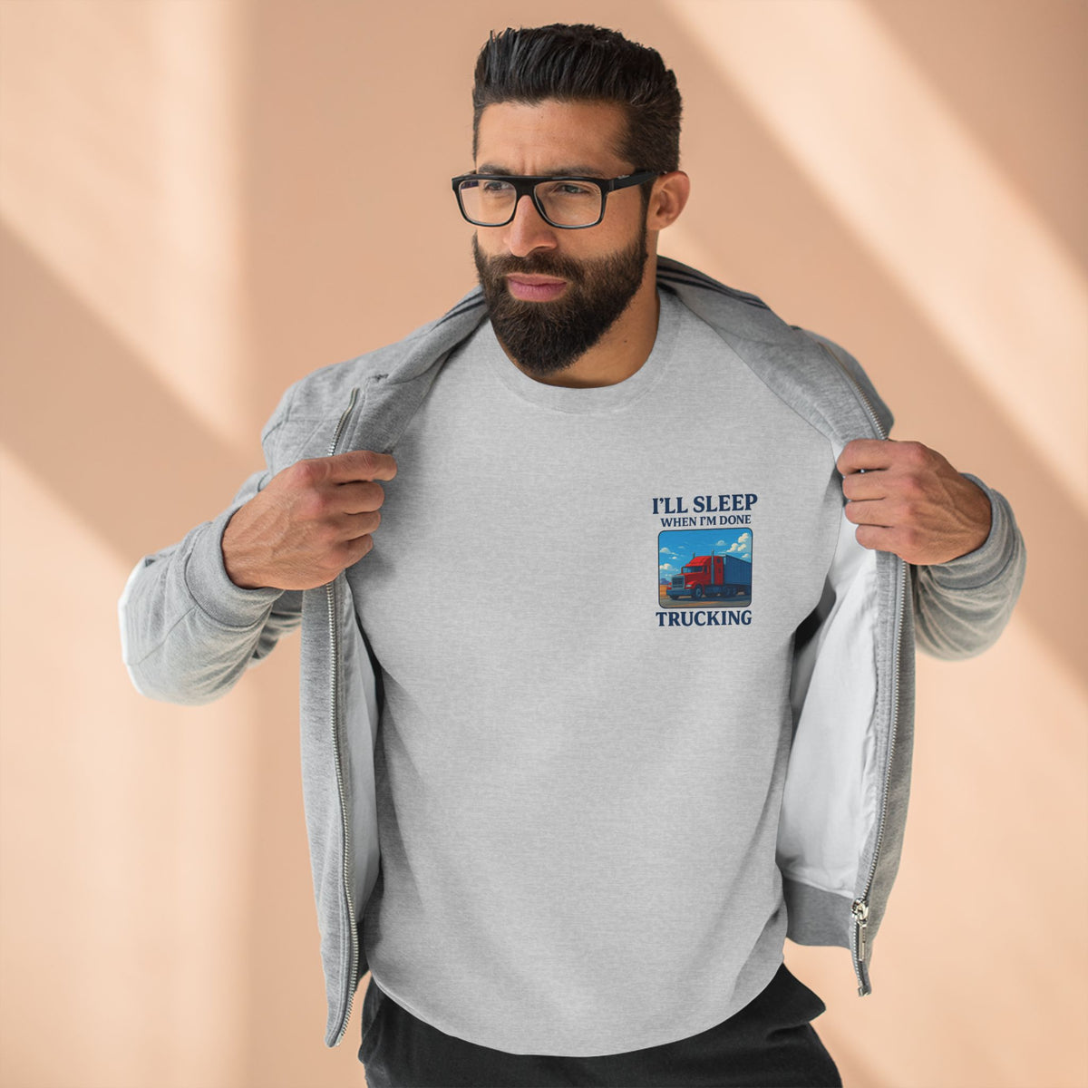 Unisex heather grey crewneck sweatshirt by Trucker Life with "I'll Sleep When I'm Done" design, casual and comfortable.