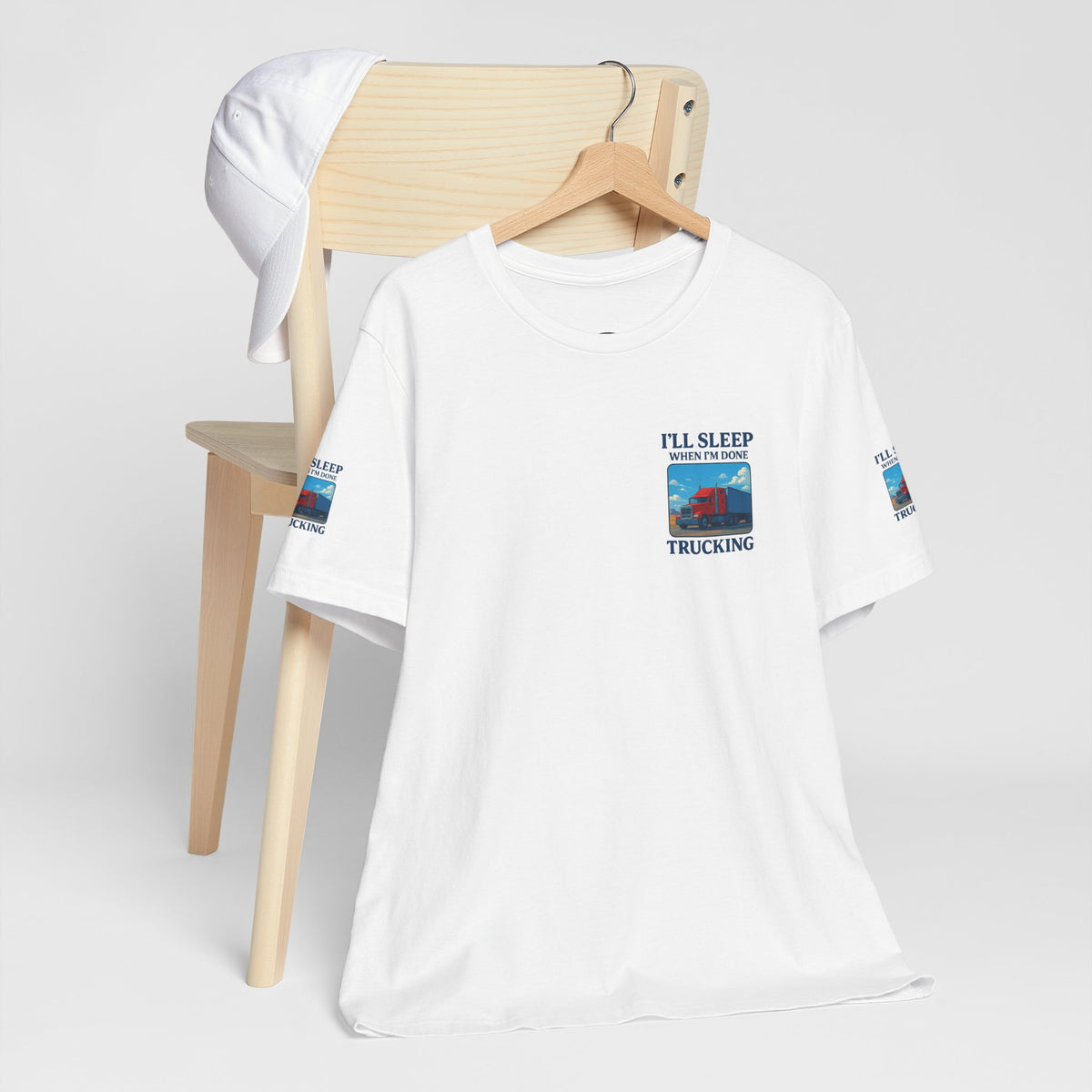 Unisex Heather gray T-shirt with "I'll Sleep When I'm Done Trucking" slogan, casual short sleeve tee for truckers by Printify.
