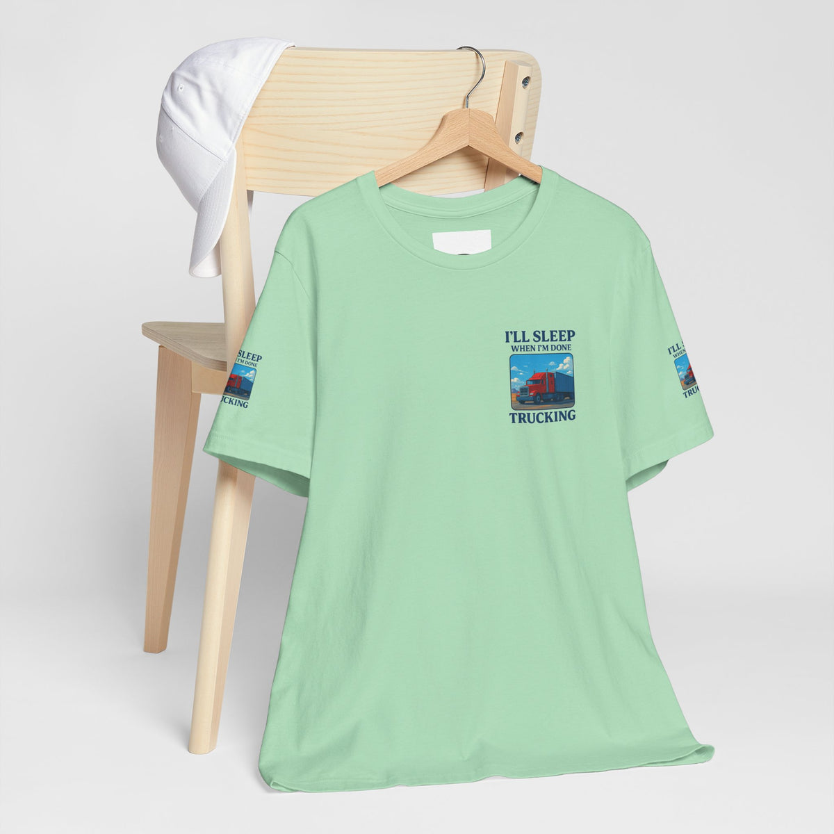 Unisex Heather Grey T-Shirt with "I'll Sleep When I'm Done Trucking" slogan for truckers, made by Printify.