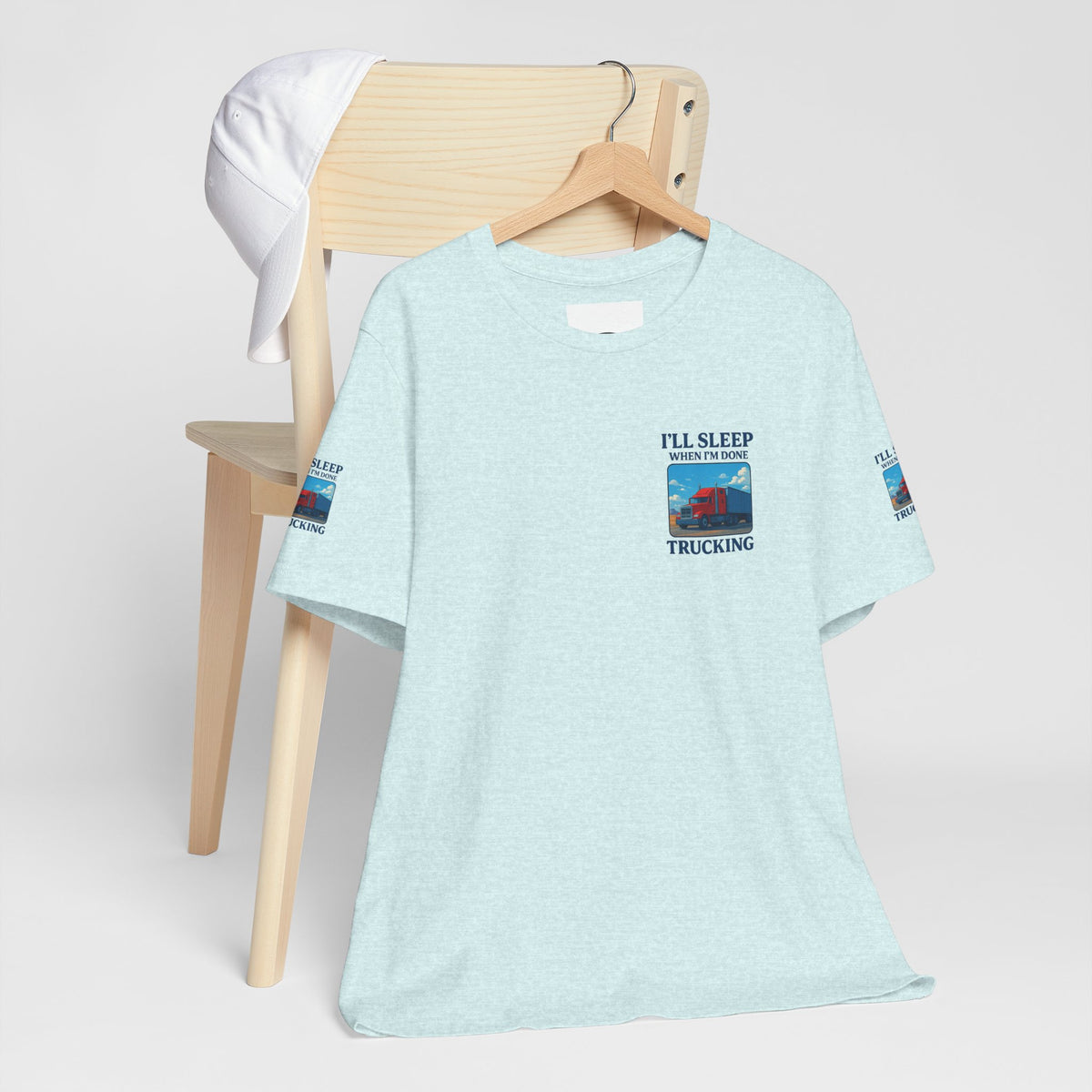 Unisex heather gray T-shirt with "I'll Sleep When I'm Done Trucking" slogan, perfect for truckers, from Printify.