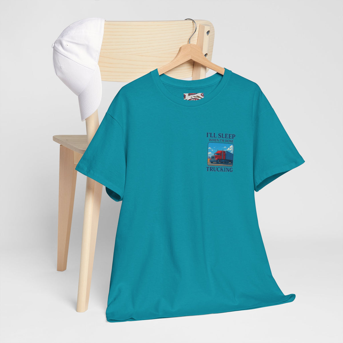 Light blue unisex heavy cotton T-shirt with "I'll Sleep When I'm Done Trucking" print, by Printify.