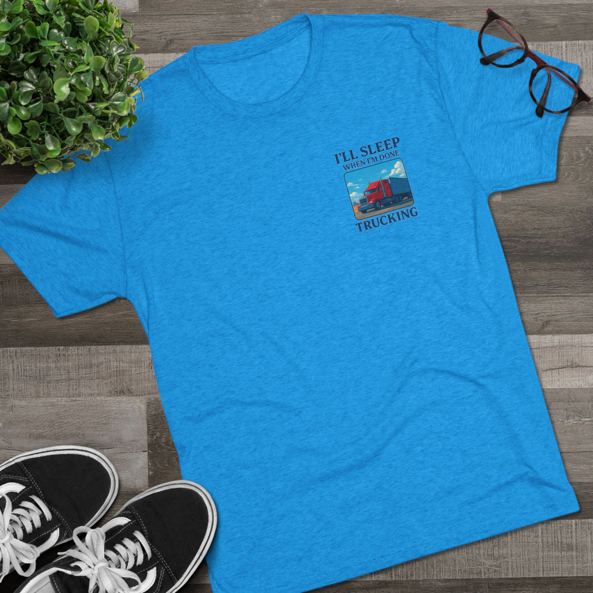 Unisex crew T-shirt with "I'll Sleep When I'm Done" slogan, featuring truck driver motivation design in tri-blend fabric.