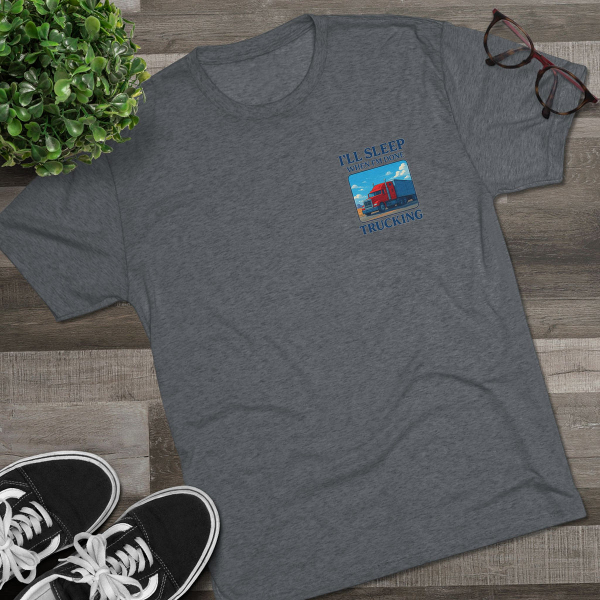 Unisex crew T-shirt with "I'll Sleep When I'm Done" slogan, featuring truck driver motivation design in tri-blend fabric.